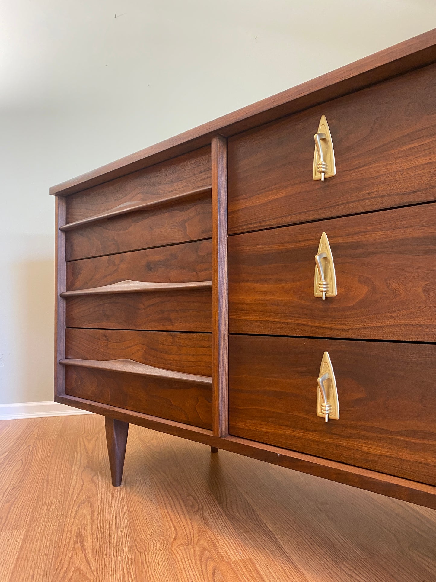 Mid Century Modern Refinished Nine Drawer Walnut Dressser with Sculpted Wooden and Gold Pulls