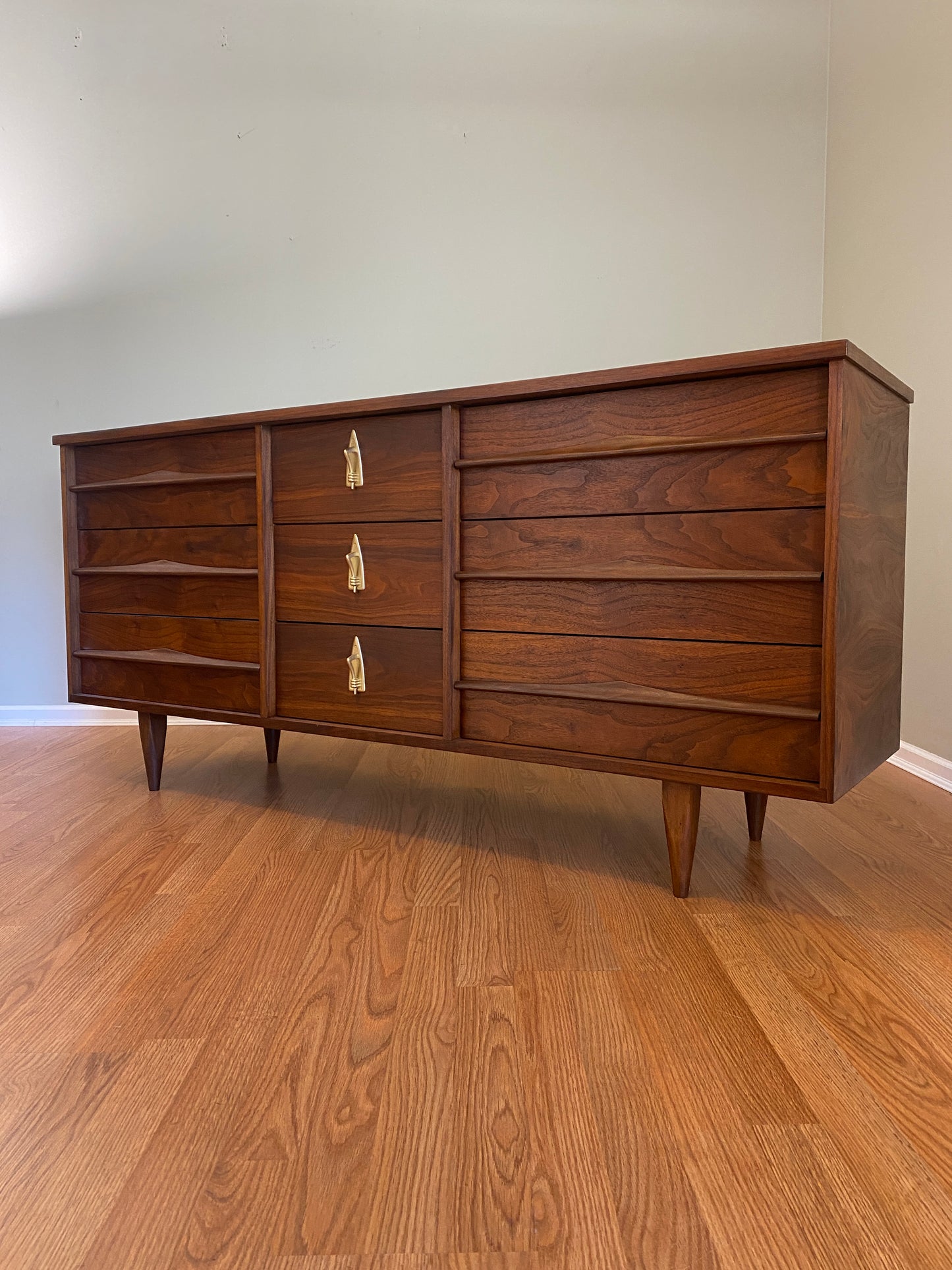 Mid Century Modern Refinished Nine Drawer Walnut Dressser with Sculpted Wooden and Gold Pulls