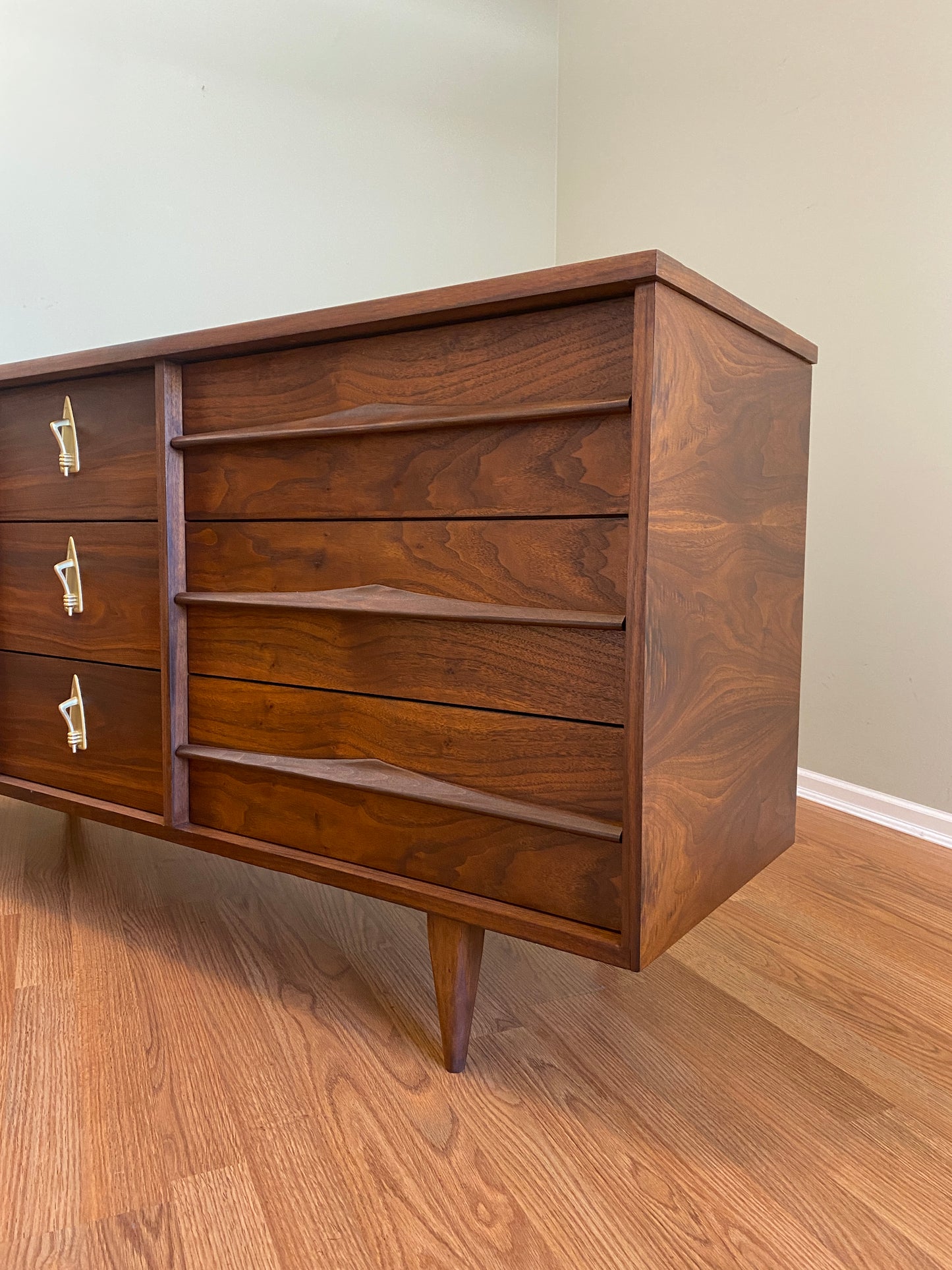 Mid Century Modern Refinished Nine Drawer Walnut Dressser with Sculpted Wooden and Gold Pulls