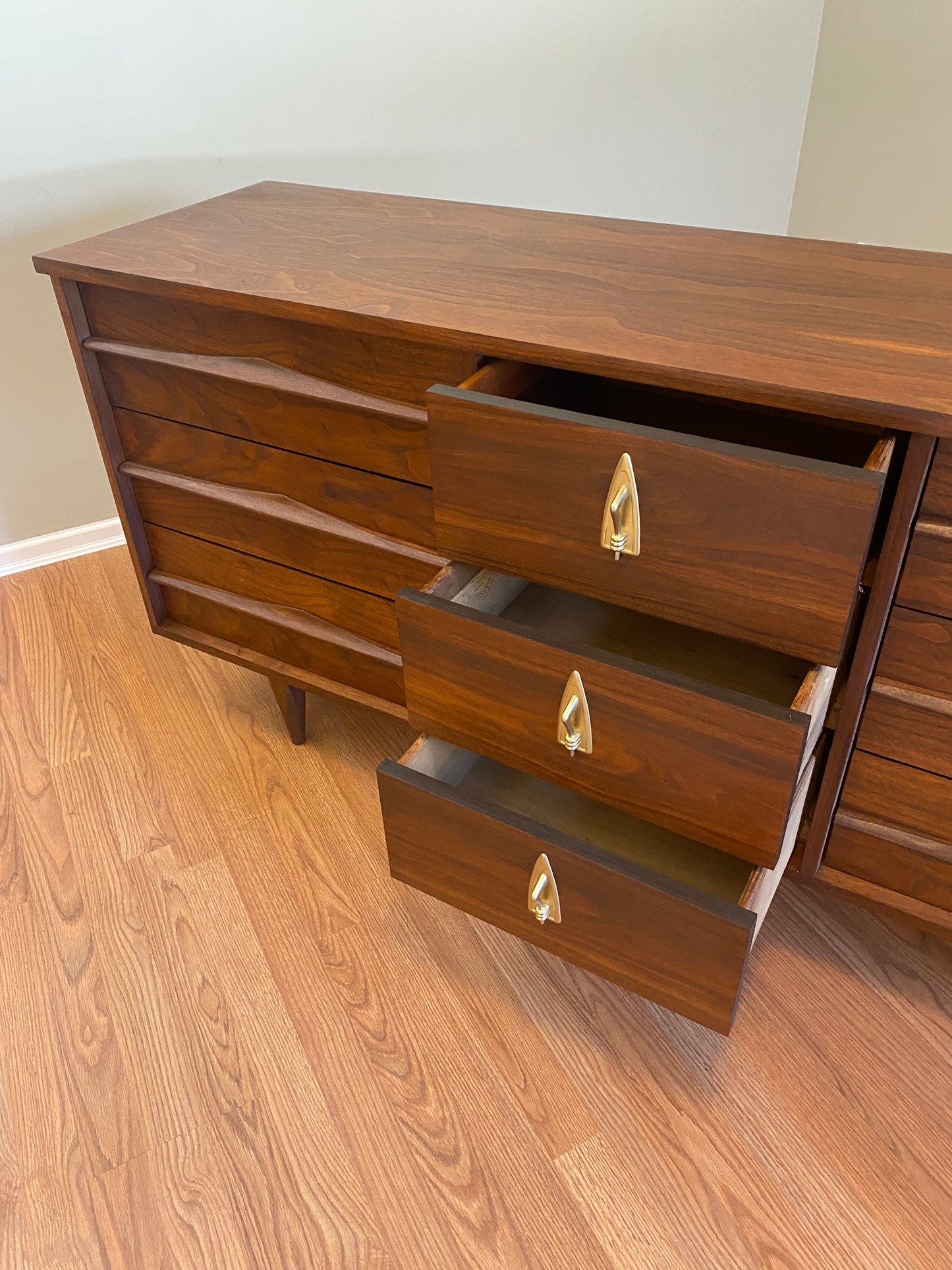 Mid Century Modern Refinished Nine Drawer Walnut Dressser with Sculpted Wooden and Gold Pulls